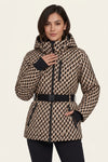 A woman modeling a hooded puffer jacket with a beige and black geometric pattern, a black belt, and black cuffs, set against a plain light beige background.